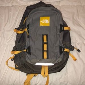 Gray and yellow North Face backpack